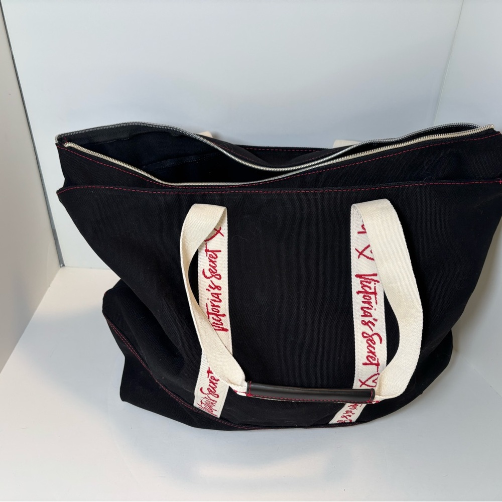 Victoria's Secret black canvas tote bag with red trim and logo